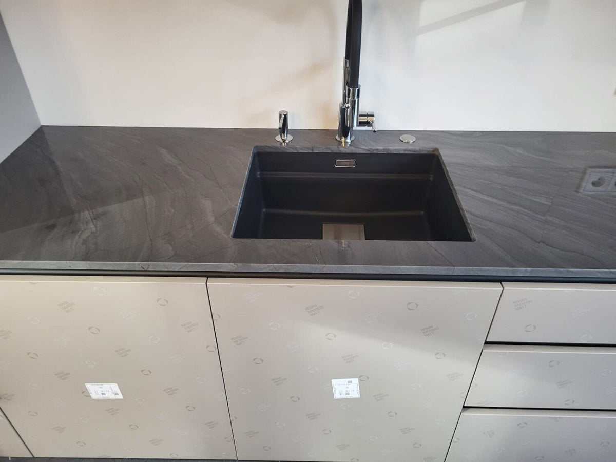 Dark grey veined ceramic countertop with a black undermount sink