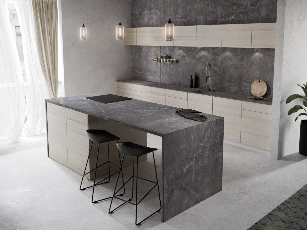 Kitchen island with a grey stone-look Dekton waterfall top, black bar stools and a matching Dekton backsplash