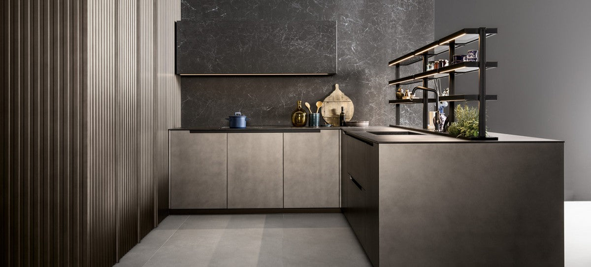 Kitchen with a grey veined Laminam slab backsplash and wall unit, bronze-toned cabinets and lit black open shelving